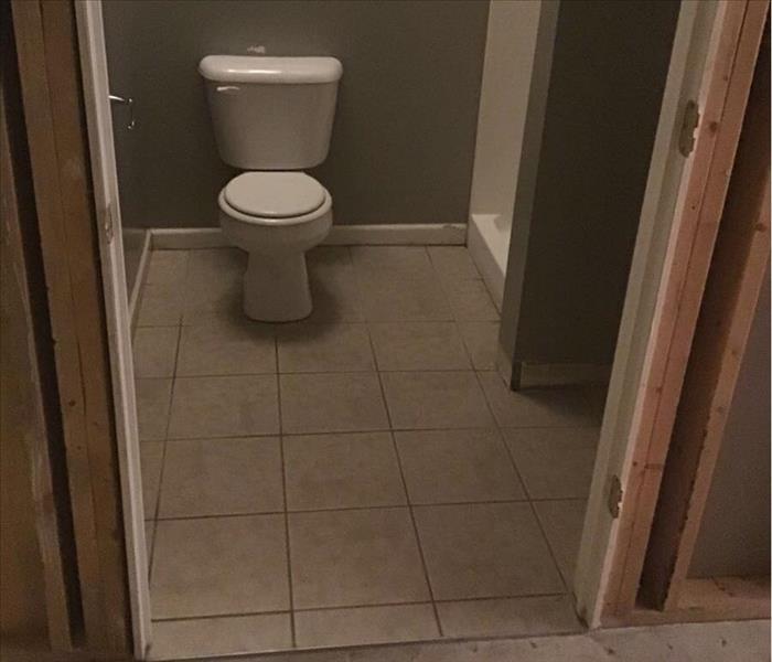 Bathroom with white tile, white toilet and gray walls