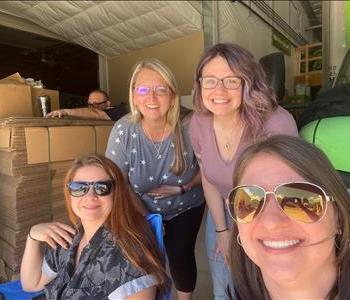 4 pretty women smiling to a camera