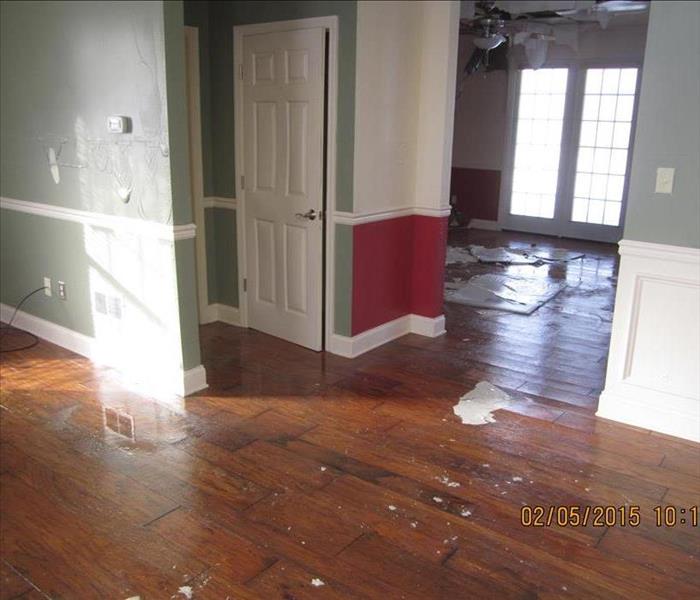 House with ceiling debris and water all over the hardwood floors