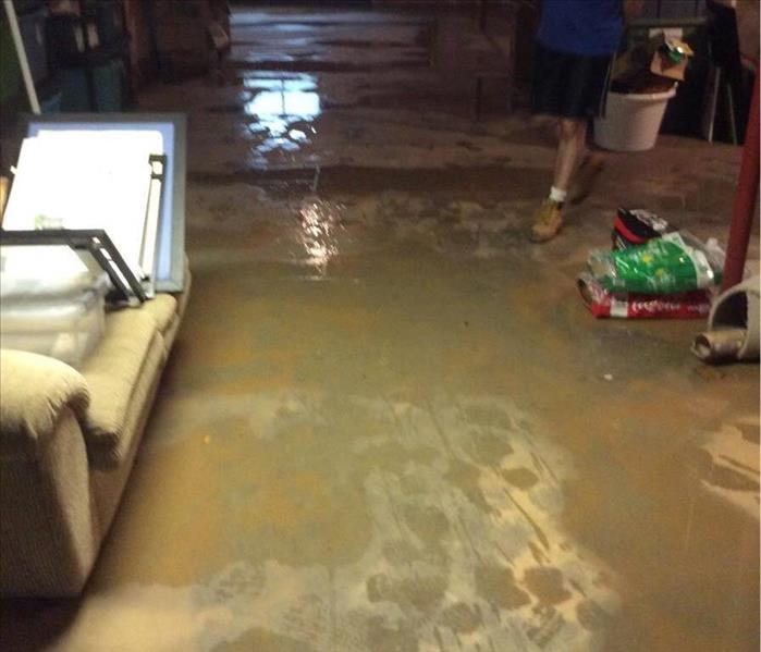 Muddy water puddles in unfinished basement