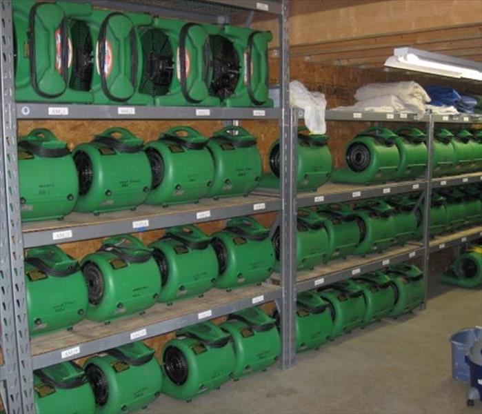 green Air Movers on shelving in warehouse