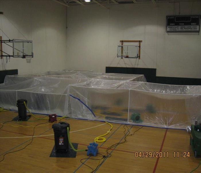 Floor mat drying system on a wet gym floor